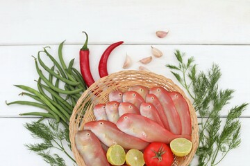 Wall Mural - Basket with fish, razor fish, fresh sea fish, on a white table, background