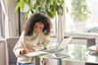 © insta_photos - Young woman, girl student using laptop elearning or remote working at home office using laptop pc computer for webinar, learning online training digital education sitting at table, writing notes.