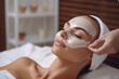 © Rawf8 - Cosmetician applying facial mask on young woman face, Skincare in a beauty salon. Generative AI