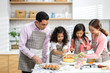 © Art_Photo - Portrait of enjoy happy love asian family father and mother with little asian girl daughter child play and having fun cooking food together with baking cookie and cake ingredient in kitchen