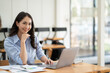 © PaeGAG - Asian woman working with laptop in her office. business financial concept.