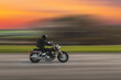 © Armands photography - Driving motorcycle with speed blurred background. A speeding motorcycle on an asphalt street. Motion blur