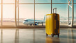 yellow suitcase stand near a large window at the airport. In the background are runway and an airplane. Tourism and travel concept background. 