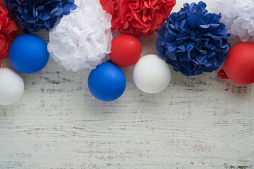 4th of July background. USA paper fans, Red, blue, white stars,  balloons, gold confetti on white wooden  background. Happy Labor Day, Independence or Presidents Day. American flag colors. Top view.