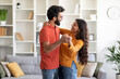 © Prostock-studio - Portrait Of Romantic Young Indian Couple Dancing Together In Home Interior