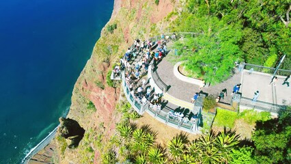 Canvas Print - Tourists enjoy the viewpoint at Cabo Girao, along the Madeira coastline, Portugal. Aerial view from drone