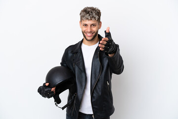 Wall Mural - Young man with a motorcycle helmet isolated on white background shaking hands for closing a good deal