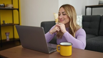 Canvas Print - Young beautiful hispanic woman using laptop drinking coffee at home