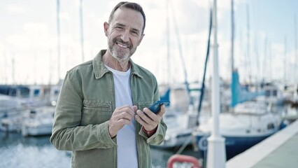 Sticker - Middle age man smiling confident using smartphone at port