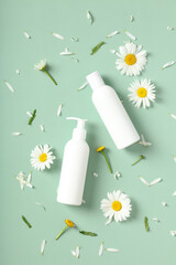 Wall Mural - SPA natural cosmetic products packaging design with chamomile flowers on pastel green background