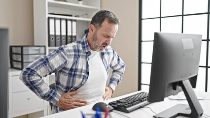 Wall Mural - Middle age man business worker suffering for stomachache working at office