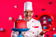 © Road Red Runner - A humorous chef proudly showcases his freshly prepared cakes, surrounded by a vibrant and colorful background. AI Generated.