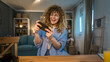 © Miljan Živković - woman caucasian play video games on smartphone mobile phone at home