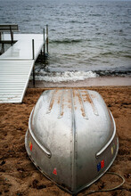 An Aluminum Boat And Dock On The Sandy Shore Of Sebago Lake, Maine