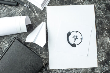 Wall Mural - overhead view of white sheet with call line drawing and notebook ruler pens blanks paper plane on gr