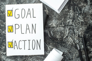 Wall Mural - top view of white sheet with goal plan action writings ticks on notebook ruler pens blanks on gray d