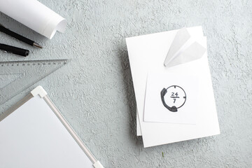 Wall Mural - top view of drawing paper plane on white sheet pens ruler desk blank on gray sand background