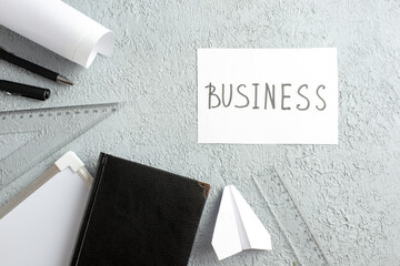 Wall Mural - top view of business writing on white sheet and black notebook paper plane pens ruler desk blank on 