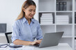 © David - Asian Business woman using calculator and laptop for doing math finance on an office desk, tax, report, accounting, statistics, and analytical research concept