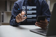 © Kannapat - Hand of young man holding a pen pointing to mark correct sign for quality document control checklist and business approve concept.