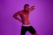 © SHOTPRIME STUDIO - Man athletic body bodybuilder in briefs with nude torso abs full-length in the background fitness classes, purple colored light. Advertising, sports, active lifestyle, competition, challenge concept.