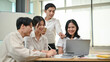 © bongkarn - A smart adult Asian male boss is coaching and briefing a new project to his young employees