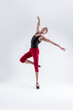 © danmorgan12 - Ballet Sport Ideas. Contemporary Ballet of Flexible Athletic Man Posing in Red Tights in Dance Pose With Hands Lifted in Studio on White.
