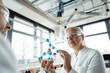 © Westend61 - Scientist with colleague examining molecular structure in laboratory