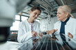 © Westend61 - Happy scientists discussing over solar panel in laboratory