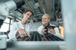© Westend61 - smiling scientists discussing over solar panel in laboratory