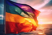 A Colorful Lgbt Flag Over The Sea With Windy Clouds And Sunlight