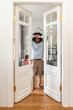 © Westend61 - Young man leaning on doors at home