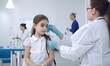 © uhdenis - Doctor immunizes a young child with a syringe. Creating using generative AI tools