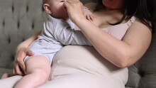 Mother Sitting With Baby Toddler Infant Under One Year New Born On Legs In Arms,pregnant Female With Second.woman Talking On Phone.child And Mom Lying On Bed,mom Kiss Kid Cuddling Caresses.4k