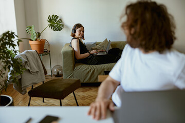 Wall Mural - Young family couple working from home office and using laptops. Distance work concept