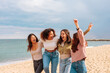 © bernardbodo - Diverse young women having fun on beach.