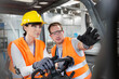 © KOTO - Worker guiding coworker driving forklift in factory