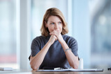 Fototapeta Miasto - Pensive businesswoman looking away in conference room