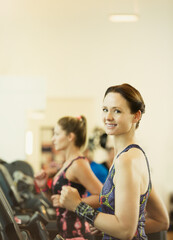 Wall Mural - Portrait smiling woman jogging on treadmill at gym