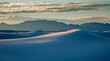 Silhouetted mountains behind tranquil white sdune, White Sands, New Mexico, United States