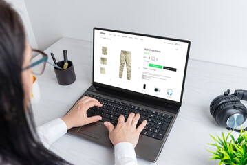 Wall Mural - shopping for clothes online. woman browses cargo pants on an ecommerce website