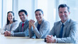 © KOTO - Portrait smiling business people sitting in a row in conference room