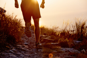 Canvas Print - Man running on craggy trail at sunset