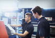 © KOTO - Workers with clipboard at machinery control panel in steel factory