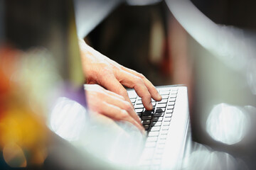 Worker typing on computer keyboard in steel factory