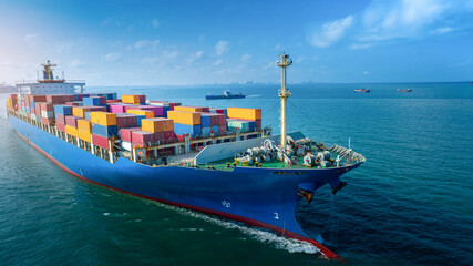 aerial side view of cargo ship carrying container and running for export goods from cargo yard port 