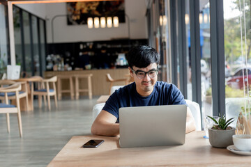 Wall Mural - asian man work using computer hand typing laptop keyboard contact us.student study learning education online.adult professional people chatting search at office.concept for technology device business