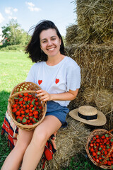 Wall Mural - Portrait of Smiling Woman with Basket of Strawberries