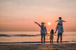 © Garun Studios - Happy asian family that enjoys beach activities during the summer holidays.