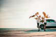 © Garun Studios - Parents carrying son and daughter at the beach on sunset in holiday.